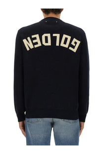 Back view of golden goose men’s blue jersey showing black knit sweater with cream colored golden lettering