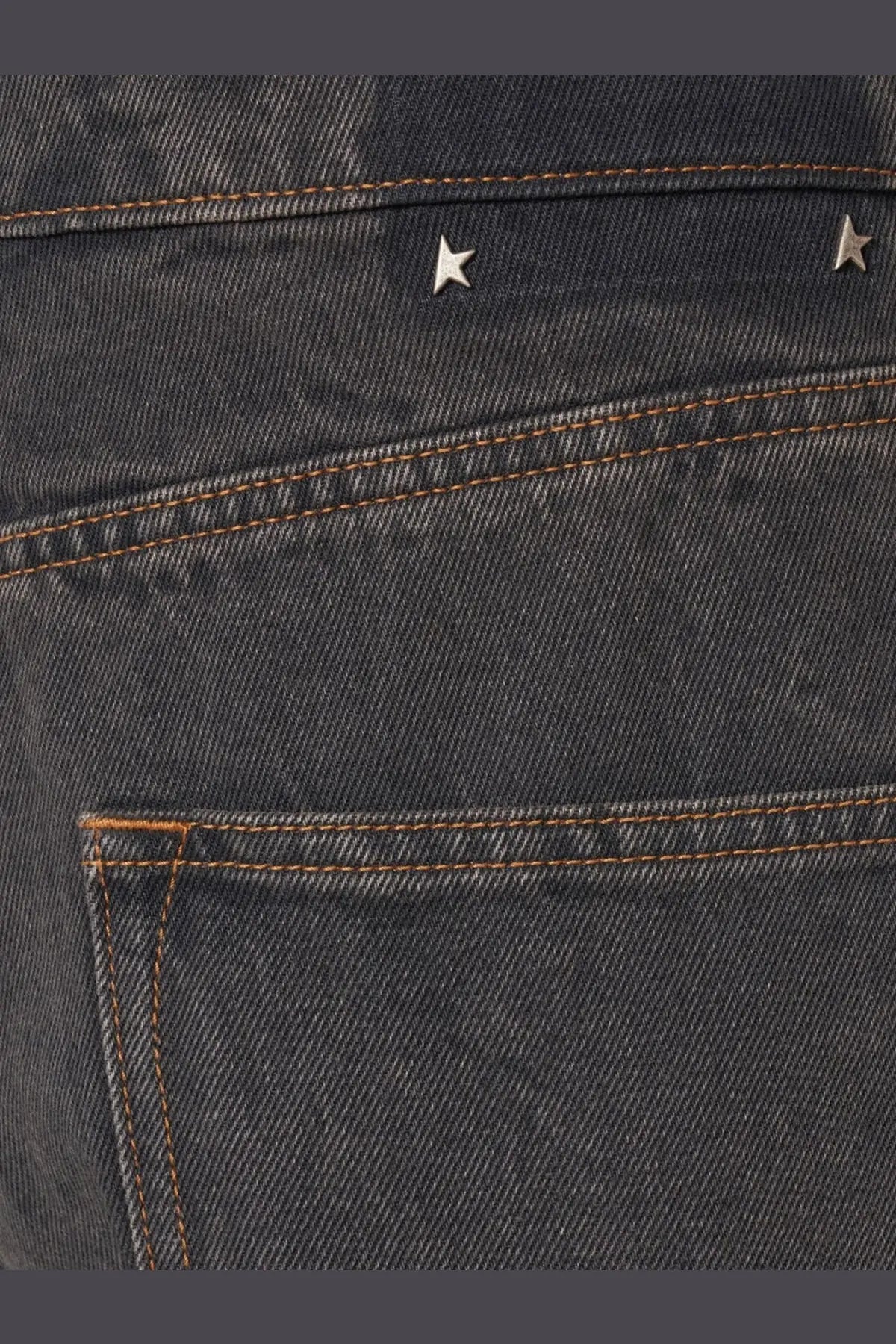 Back side of golden goose men’s ms pant cory loose skate jeans black in dark wash with two silver star studs above pocket