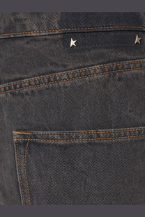 Back side of golden goose men’s ms pant cory loose skate jeans black in dark wash with two silver star studs above pocket
