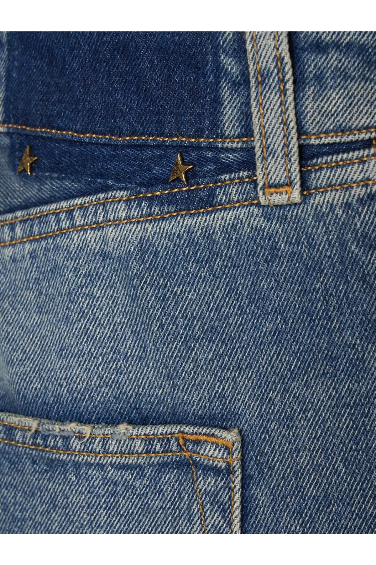 Back side of golden goose men’s blue denim happy jeans with gold star metal studs on the back pocket