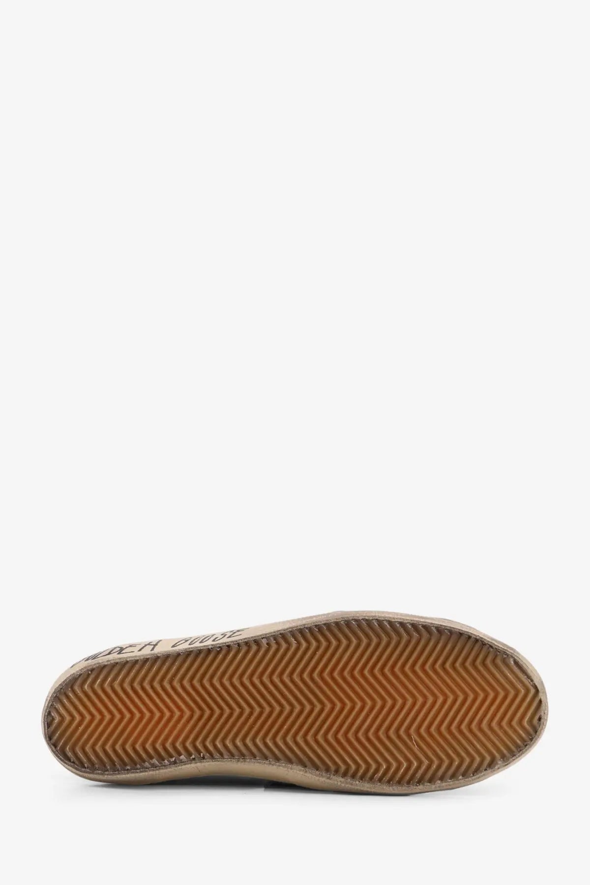Beige suede low-top sneaker with brown chevron tread sole and golden goose brand name on heel back side