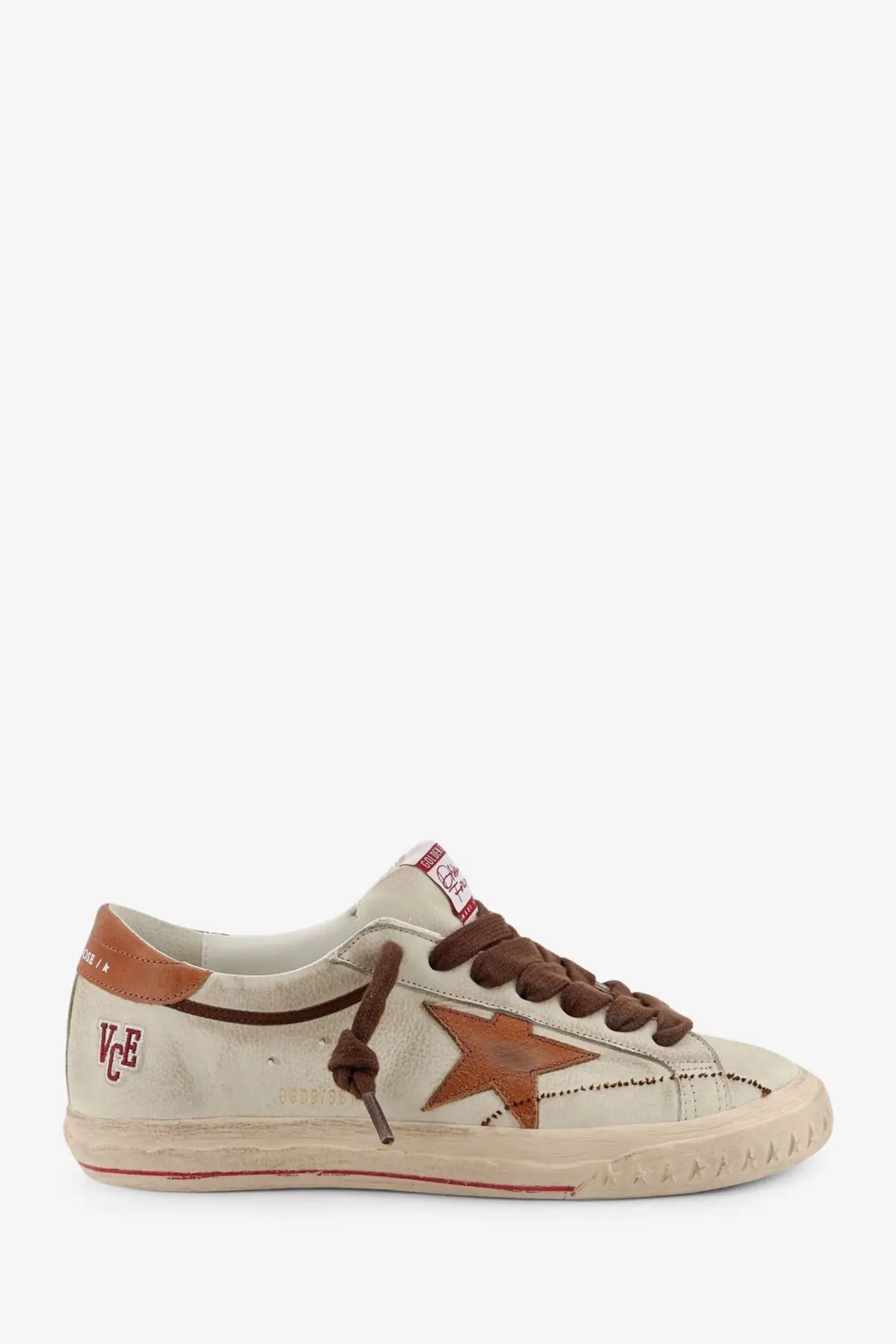 Beige suede Golden Goose men’s Super Star low-top sneaker with brown star patch tan leather accents and red stitching details