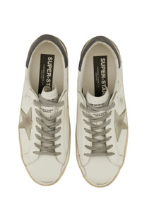 Golden Goose mens Super Star white leather sneakers with metallic star