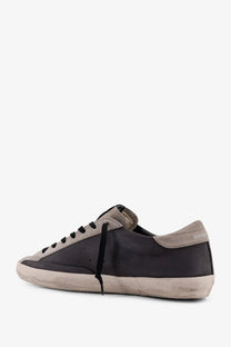 Black leather golden goose men’s superstar sneaker with grey distressed sole and beige suede accents