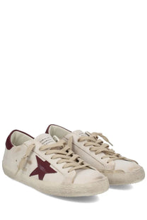 Golden Goose men’s superstar cream suede sneakers with maroon star logo and matching heel tab in white color