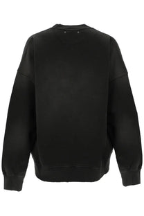 Black oversized crewneck sweatshirt with ribbed cuffs and hem featuring subtle star shaped metallic details at neckline