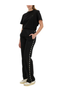 Golden goose women’s black jersey shirt paired with black star-trimmed sleek straight-leg trousers with subtle side detailing