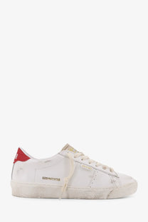 White distressed leather golden goose matchstick low-top sneaker with red heel tab and gold branding for women