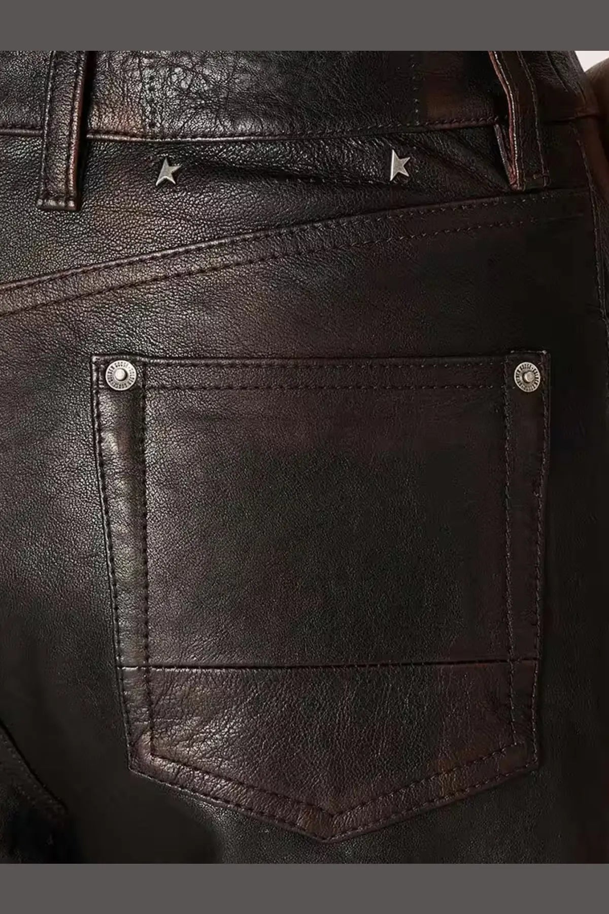 Back view of golden goose women’s peg leather trousers blue in dark brown with silver rivets and star-shaped studs