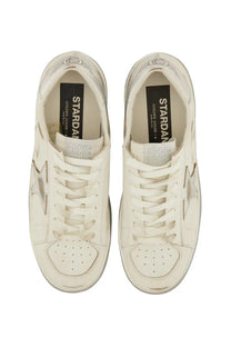 Cream-colored leather Golden Goose women’s Stardan sneaker with metallic star emblem and classic lace-up design