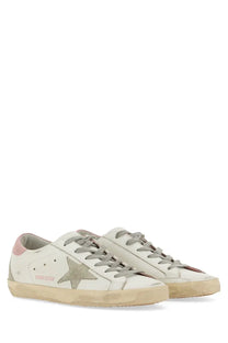 Golden goose women’s super star white leather sneakers with metallic star emblem pink heel and distressed sole