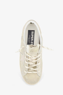 Golden Goose women’s Super Star suede sneaker in beige with white laces and a distressed finish