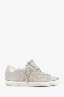 Golden Goose women’s super star beige suede sneaker with light gray star emblem and glittery sole trim