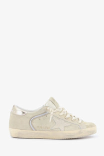 Golden Goose women’s super star low-top sneaker in beige suede with silver star patch and distressed rubber sole