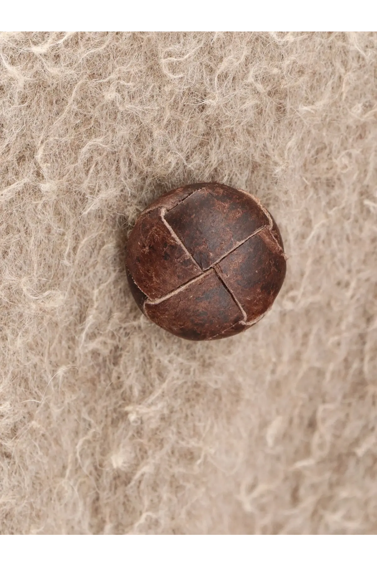 A round dark brown leather button with cross-stitched design on golden goose women’s wrinkled virgin wool blend grey coat
