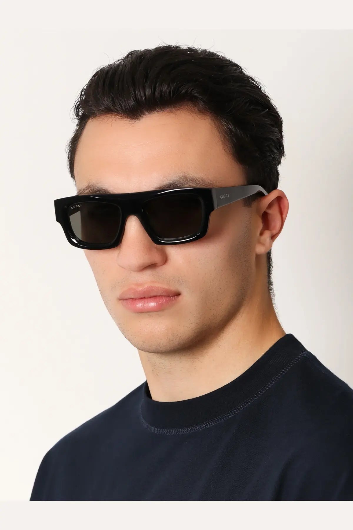 Gucci men’s acetate sunglasses in black with dark lenses and a sleek modern rectangular design