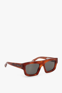 Gucci men’s acetate sunglasses with brown tortoiseshell frames and dark gray lenses for stylish sun protection