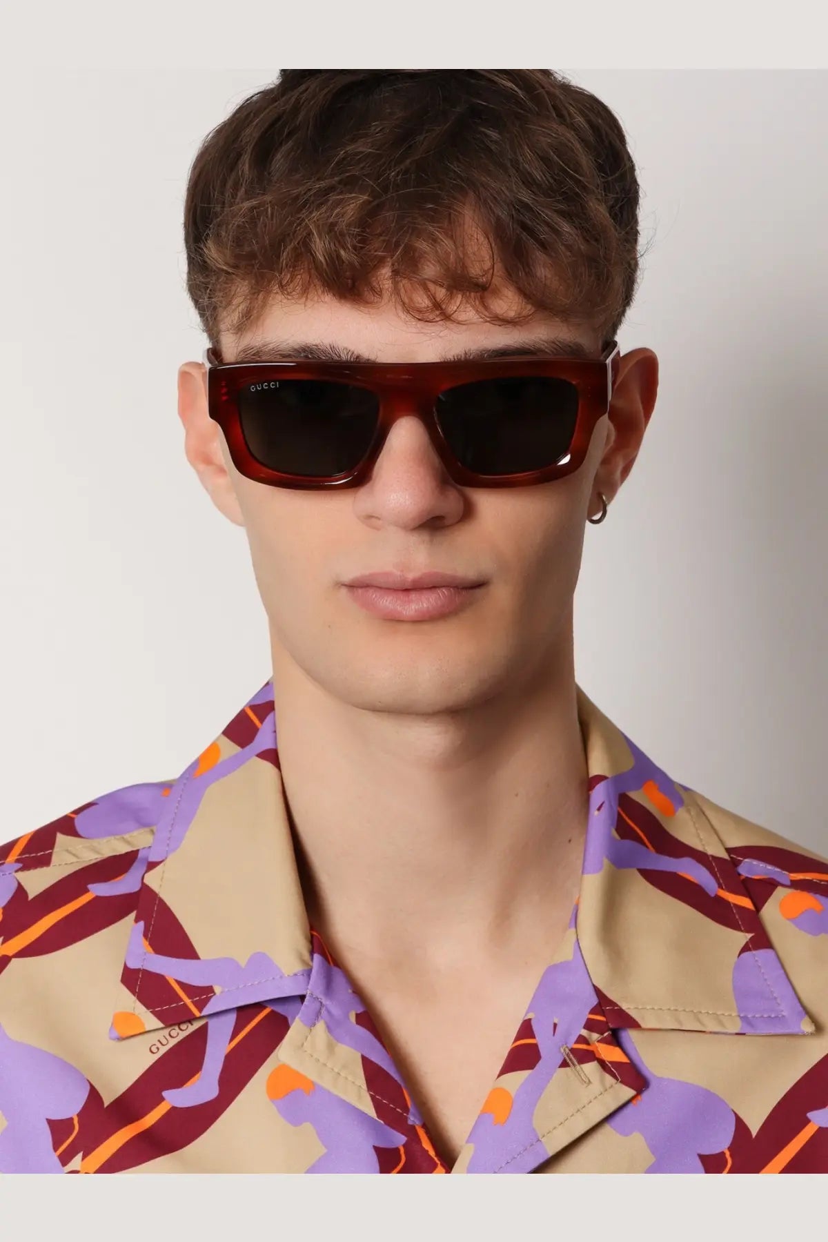 Burgundy-tinted rectangular gucci men’s acetate sunglasses with dark lenses and a sleek modern frame