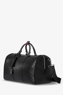 Black gucci men’s coated canvas duffle bag with embossed gg emblem pattern and leather handles for travel use