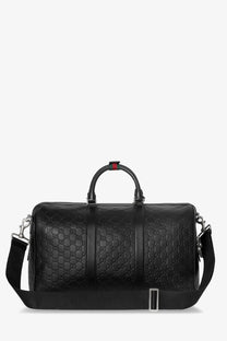Black gucci gg supreme leather duffel bag with signature interlocking g pattern and red handle accent for travel
