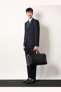 Black textured leather gucci men’s duffel bag with red and black handles for travel use