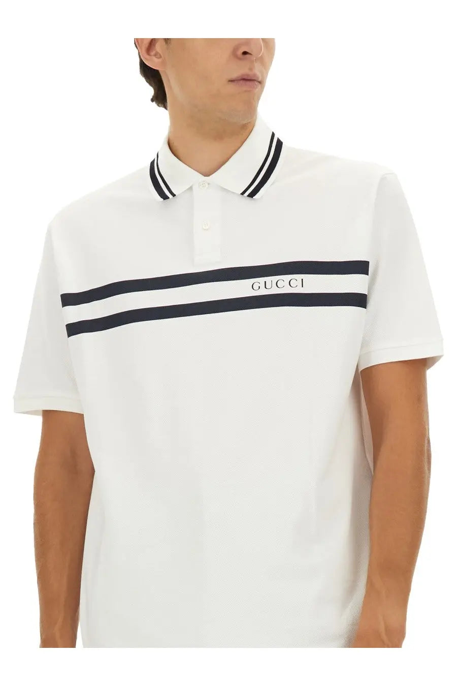 White gucci men’s cotton pique polo shirt with black striped collar and navy chest stripes featuring logo embroidery