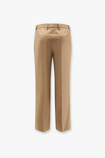 Gucci men’s beige cotton trousers with a sleek tailored fit and subtle creasing along the wide legs