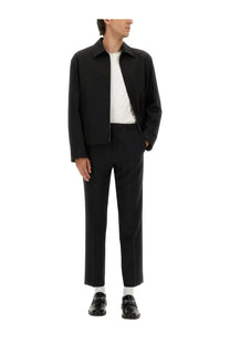 Gucci men’s black cotton twill tailored jacket with classic collar and front zipper worn over white tee
