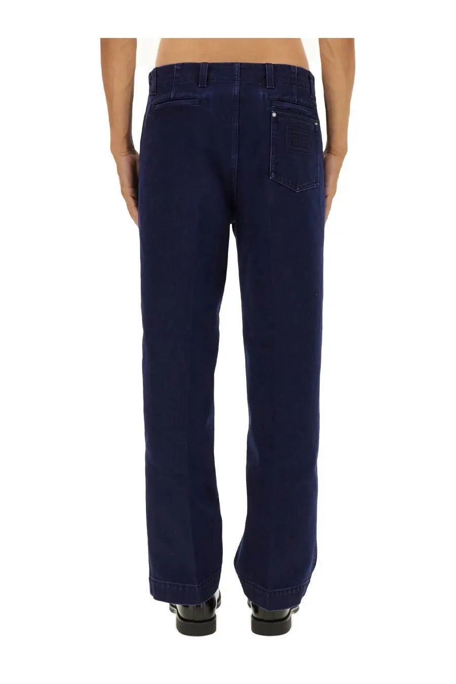 Back side of gucci men’s élavé denim pants in dark blue with classic pocket design and subtle stitching details