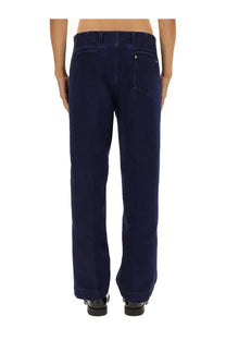 Back side of gucci men’s élavé denim pants in dark blue with classic pocket design and subtle stitching details