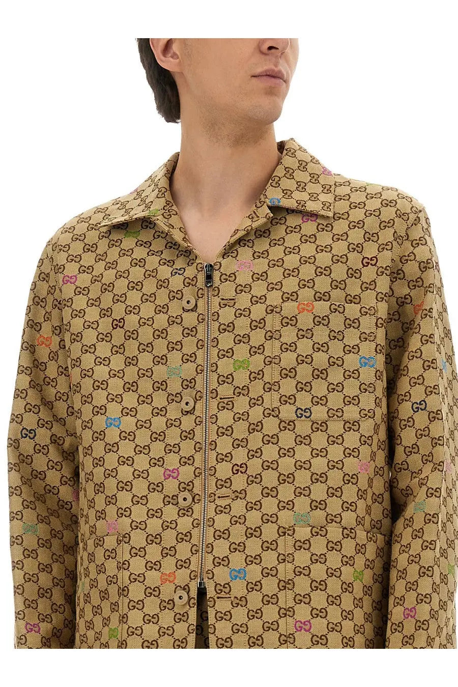 Beige Gucci men’s fabric jacket with repeating gg monogram and colorful cartoon character accents