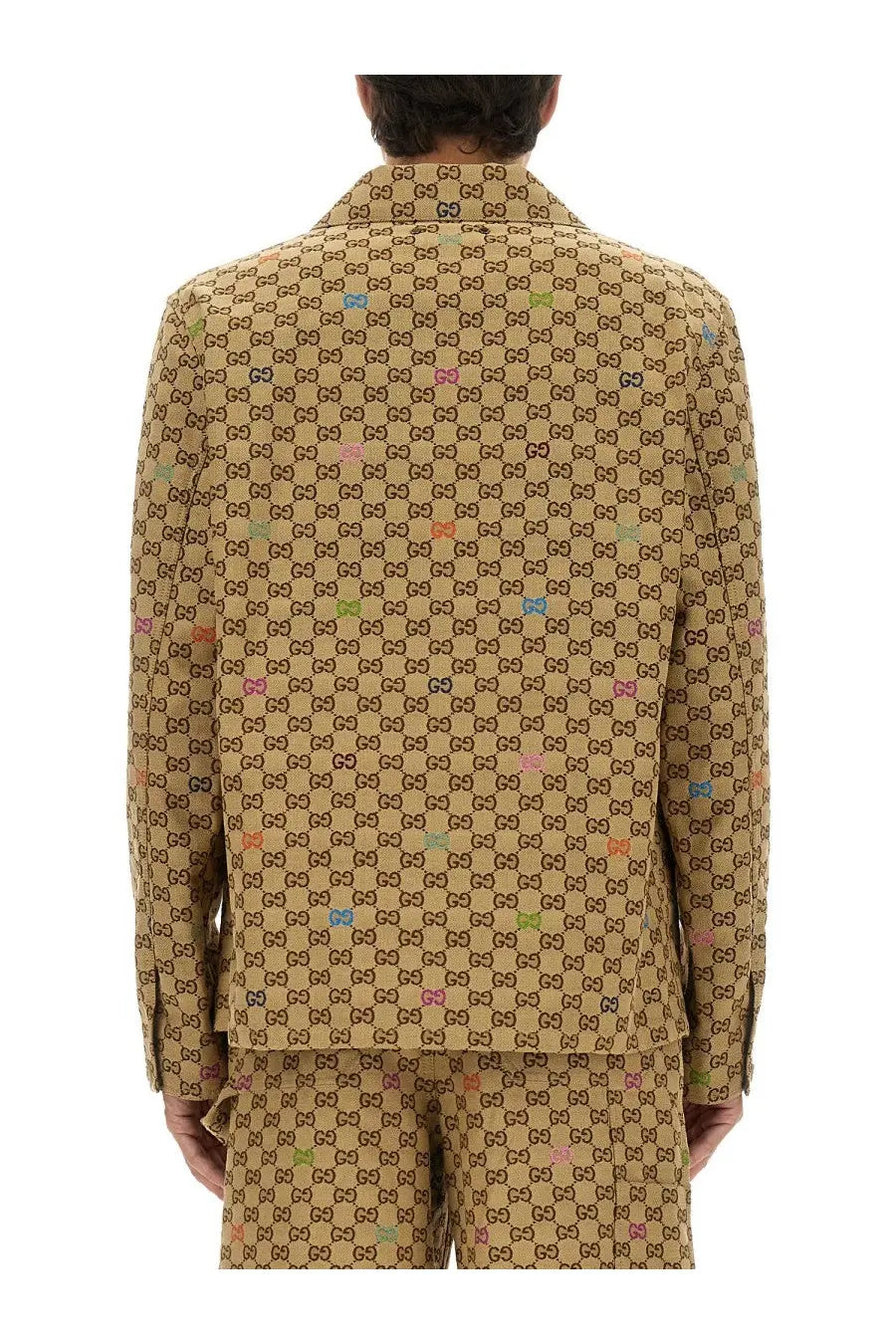 Gucci men’s beige fabric jacket featuring a tan suit with brown gg logo pattern and multicolored accents