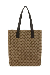 Beige and brown Gucci men’s fabric shopping bag GG medium with black leather handles and GG supreme canvas tote design