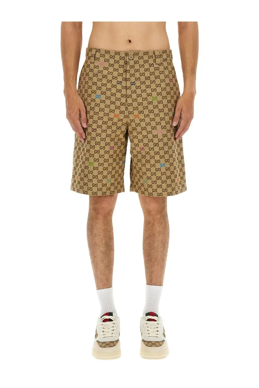 Beige Gucci men’s fabric shorts featuring a repeating GG logo pattern with subtle multicolored accents