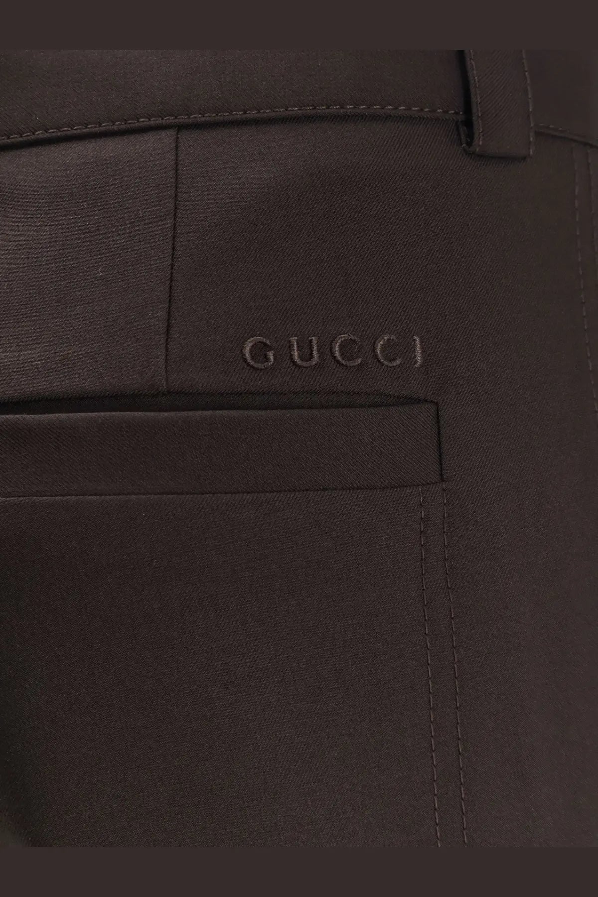Gucci men’s dark brown leather trousers with subtle embossed logo on front pocket in gabardine wool style