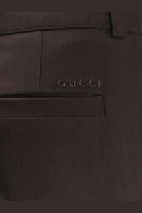 Gucci men’s dark brown leather trousers with subtle embossed logo on front pocket in gabardine wool style