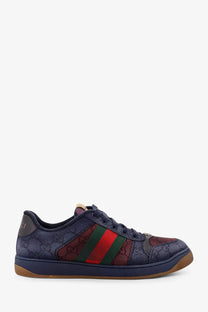 Gucci men’s navy blue sneaker with gg supreme canvas upper and red green striped webbing on the side