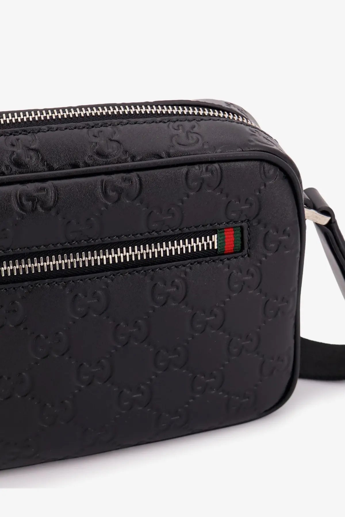 Gucci men’s black leather crossbody camera bag with embossed GG monogram and silver-toned zipper hardware