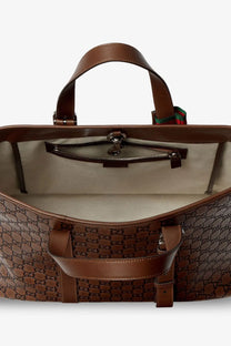 Brown gucci gg supreme leather tote bag with top handle and side straps in black gucci men’s emblem leather shopping bag