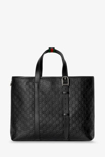 Black Gucci men’s GG emblem leather tote bag with signature interlocking G pattern and red-green striped handle tab