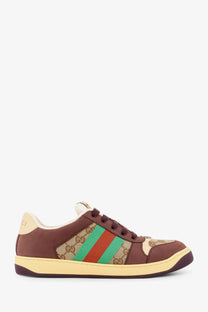 Brown Gucci men’s GG fabric leather sneaker with beige and green stripes featuring the iconic GG monogram pattern