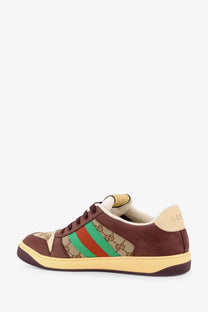 Brown Gucci men’s GG fabric leather sneakers with beige and green striped accents and iconic GG monogram pattern