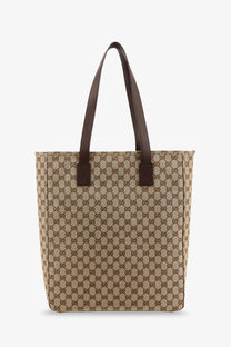 Beige and brown Gucci men’s GG fabric shopping tote bag with leather handles in GG supreme canvas material
