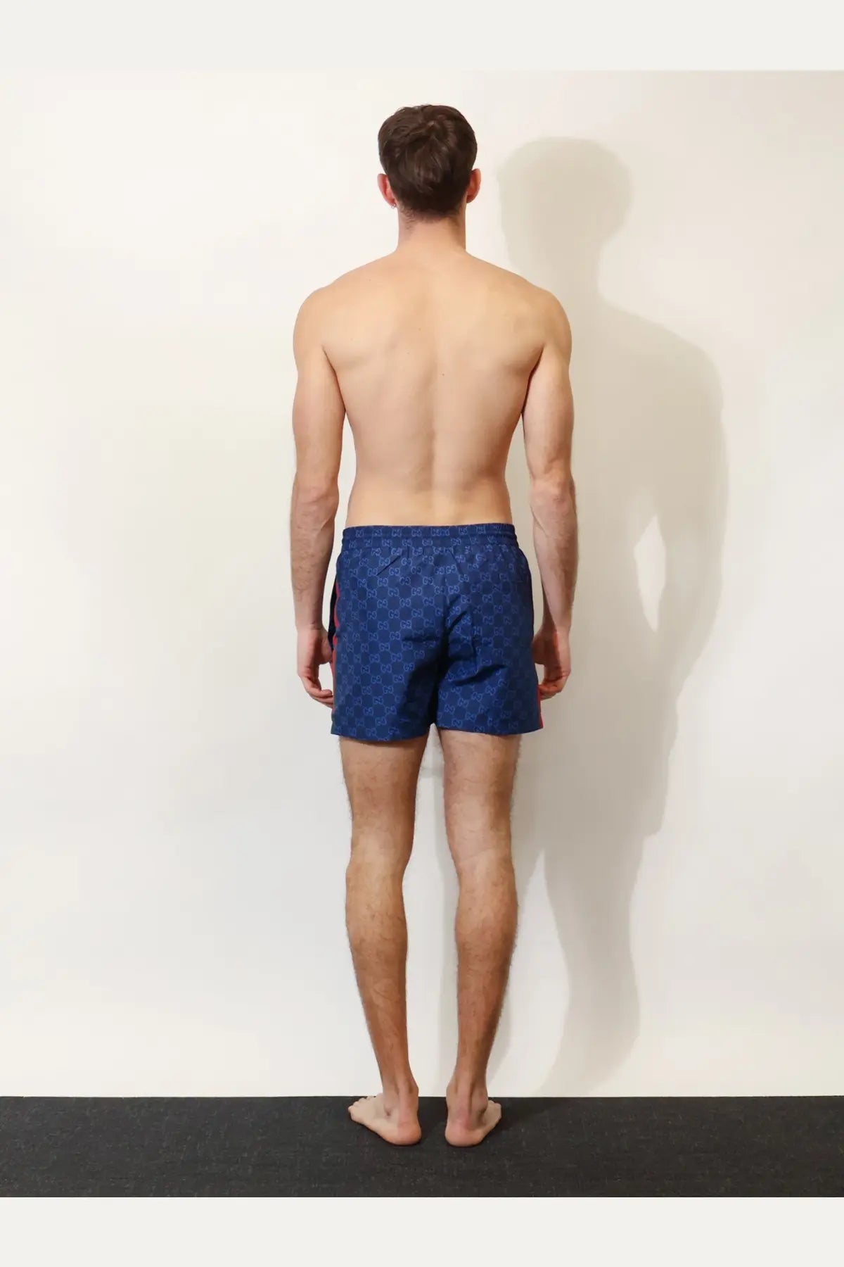 Gucci men’s blue nylon swim trunks with a repeating GG monogram pattern ideal for swimming and beachwear