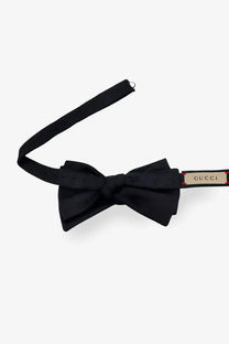 Black gucci men’s gg silk bow tie with sleek satin finish and branded tag on adjustable strap