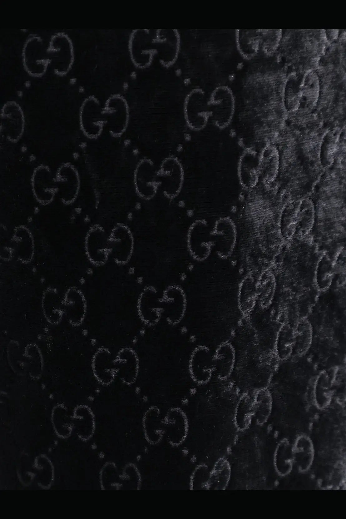 Black velvet fabric with embossed gucci interlocking g logo pattern on gucci men’s gg stretch devoré velvet trousers