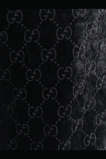 Black velvet fabric with embossed gucci interlocking g logo pattern on gucci men’s gg stretch devoré velvet trousers