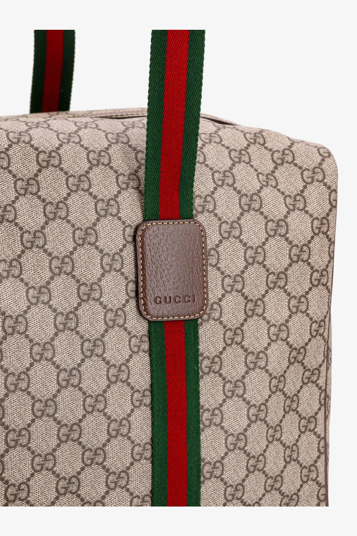 Beige gucci men’s gg supreme canvas tote bag with red and green shoulder strap and brown leather patch