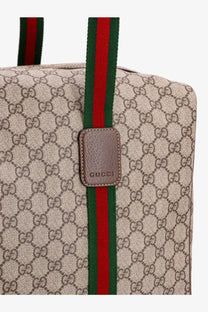 Beige gucci men’s gg supreme canvas tote bag with red and green shoulder strap and brown leather patch