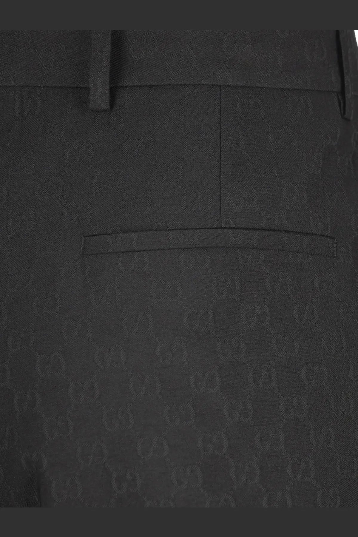 Black gucci men’s gg wool blend trousers featuring a subtle gg supreme monogram pattern and classic fit